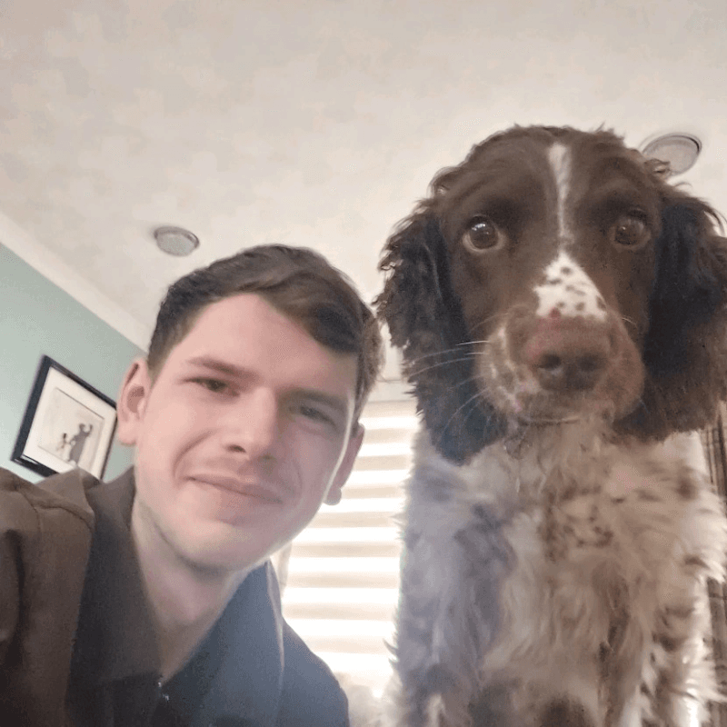Adam Salter at home with his spaniel